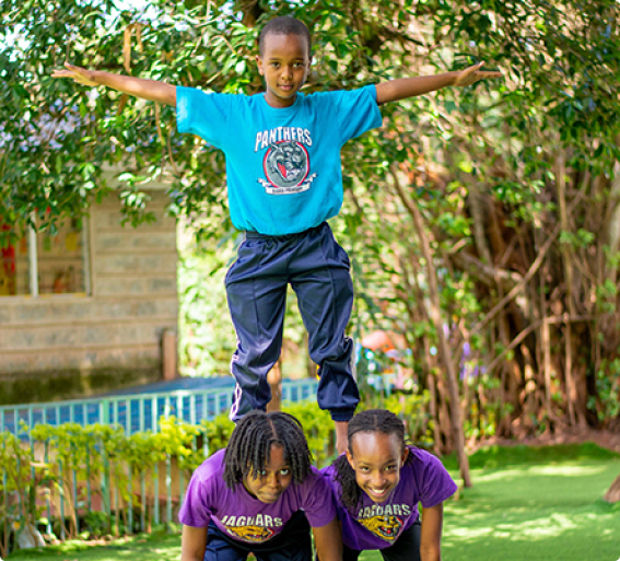 Riara pupils playing acrobatics outdoors