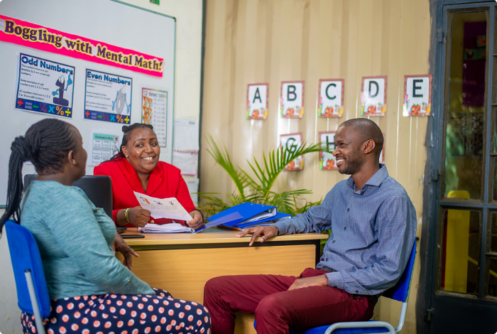 Riara teacher and parents conversing in her office