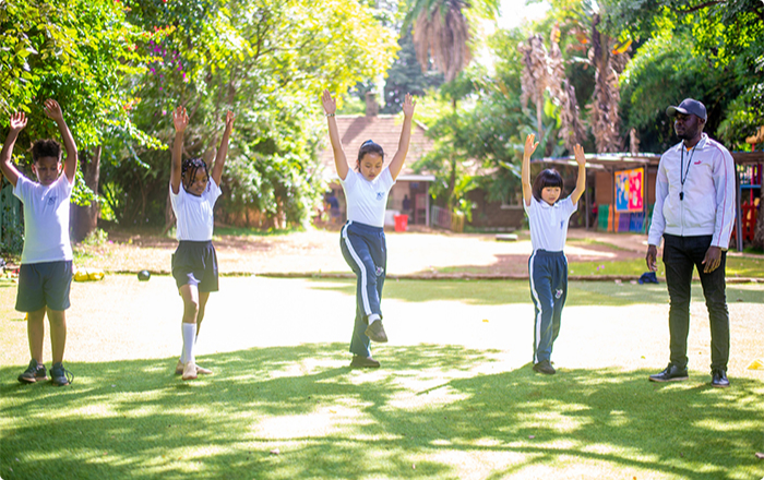 Riara International School students with a sports teacher doing exercises