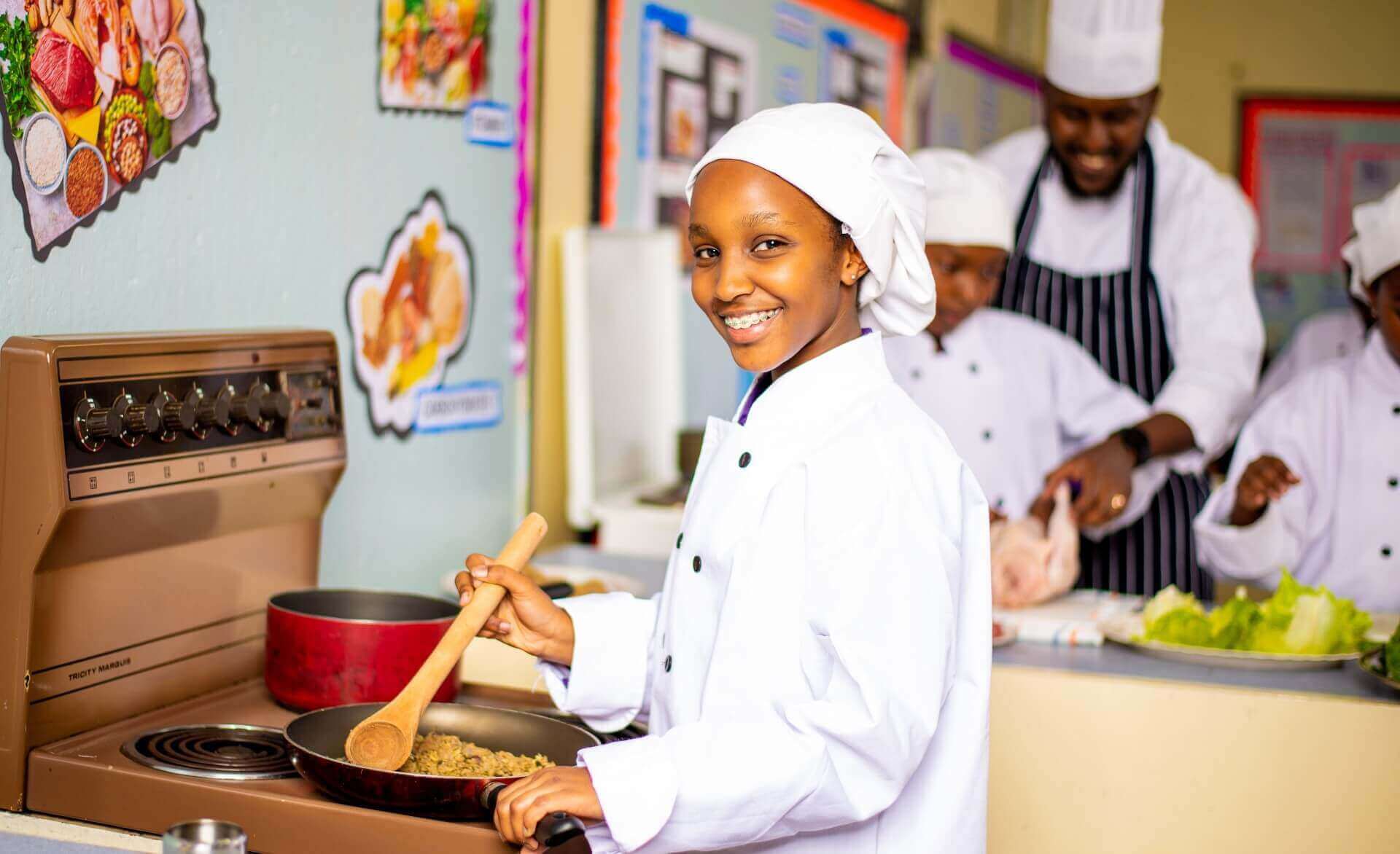 Riara springs junior high school students preparing food in kitchen under supervision of a chef
