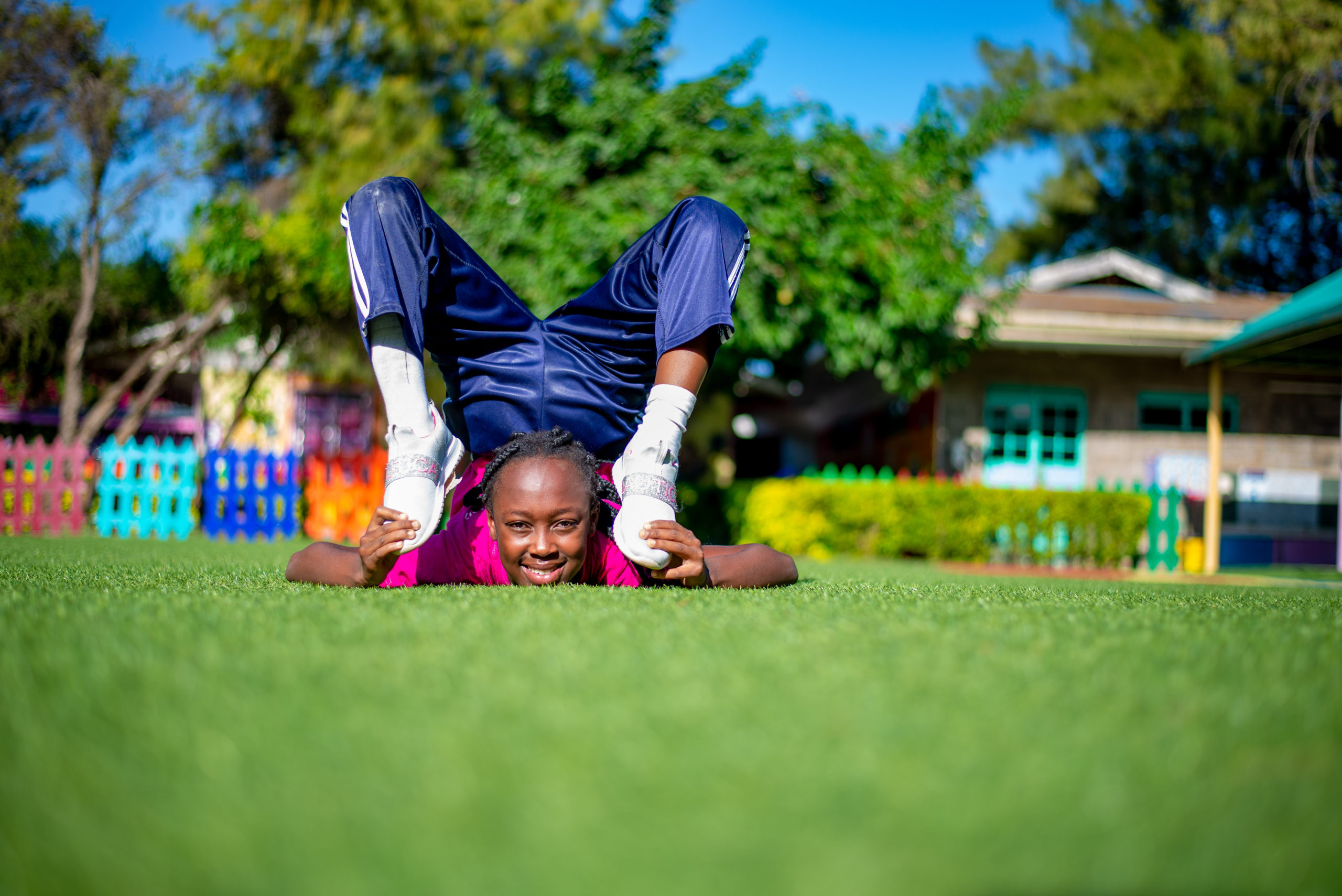 Riara Springs Primary School pupil showcasing acrobatics in track suit